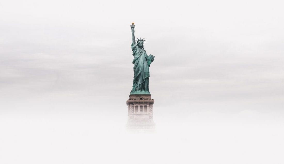 statue of liberty in dense fog, nyc