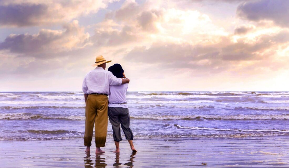a couple standing looking at galveston beach