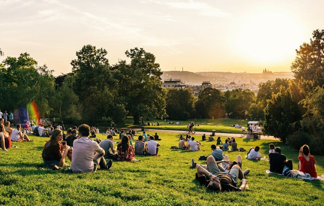 people sitting on the grass in Riegrovy Sady park in Prague