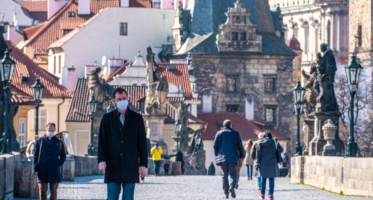man wearing mask charles bridge prague pandemic
